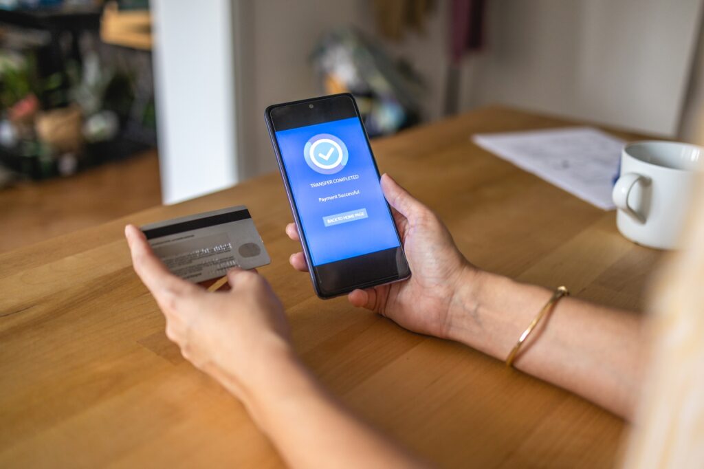 Young woman Paying Bills with mobile phone